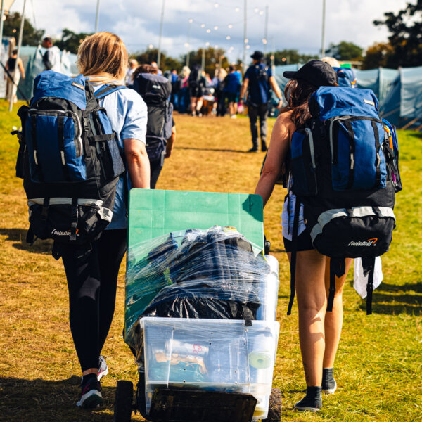 Two People Carrying a Trolley