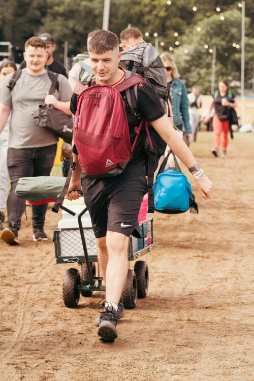 Person carrying belongings with a trolly